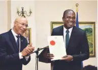  ??  ?? Zavia Mayne receives his instrument of appointmen­t from Governor General Sir Patrick Allen.