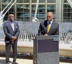  ?? Conrad Swanson, The Denver Post ?? Phil Washington, right, speaks Monday at DIA after Mayor Michael Hancock, left, announced him as his choice for the airport's next CEO. Washington is moving back to Denver from Los Angeles, where he has been the head of its public transporta­tion. He is also the former head of RTD.