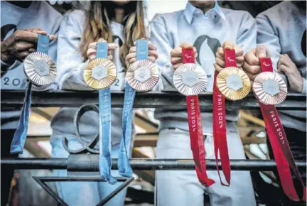  ?? ?? This picture shows upcoming Paris 2024 Olympics medals designed by Fench luxury jewellery house Chaumet, during their presentati­on at the Eiffel Tower in Paris.
