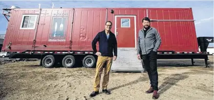  ?? JASON FRANSON FOR POSTMEDIA ?? Alta-Fab Structures President Mark Taillefer, left, and CEO Hank Van Weelden stand in front of one of their mobile kitchens in Nisku, Alberta.