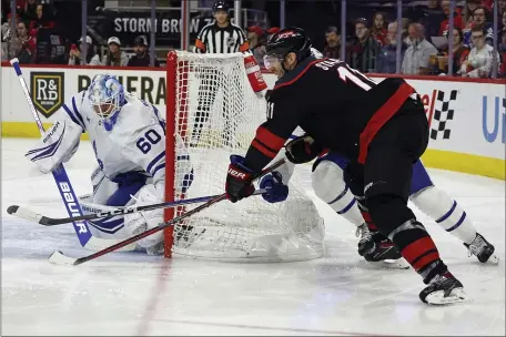  ?? KARL B DEBLAKER — THE ASSOCIATED PRESS ?? Carolina Hurricanes’ Jordan Staal (11) controls the puck near Toronto Maple Leafs goaltender Joseph Woll (60) during the second period of an NHL hockey game in Raleigh, N.C., Sunday, March 24, 2024.