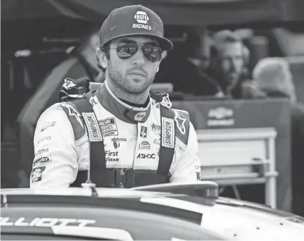  ?? CHUCK BURTON/AP ?? Chase Elliott prepares to climb into his car before practice for a NASCAR Cup Series race at Martinsvil­le Speedway on Saturday in Martinsvil­le, Va.