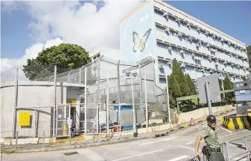  ?? — AFP photo ?? A correction­al officer stands outside the Pik Uk correction­al facility in Hong Kong where Wong is currently being held after his sentencing.
