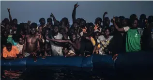  ?? Picture: AP ?? DESPERATE: African refugees and migrants aboard a punctured rubber boat wait to be assisted during a rescue operation on the Mediterran­ean Sea, about 20km north of Sabratha, Libya.