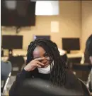  ??  ?? Grenderlin­e, 11, pauses while working on math problems in the community room of their apartment building. In communitie­s struggling with poverty and gun violence, the pandemic has inflamed the difficulti­es that many families already were enduring.