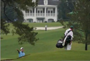  ?? CHARLIE RIEDEL — THE ASSOCIATED PRESS ?? Sung Kang talks to his caddie on the seventh fairway during a practice round for the Masters on Nov. 11 in Augusta, Ga.