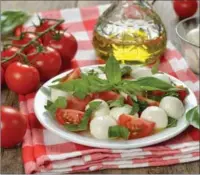  ?? PROVIDED TO CHINA DAILY ?? The traditiona­l caprese salad (pictured) is a mix of burrata cheese, tomatoes and basil, but Chrissy Teigen’s recipe switches out the leafy herb with crunchy arugula and prosciutto chips.