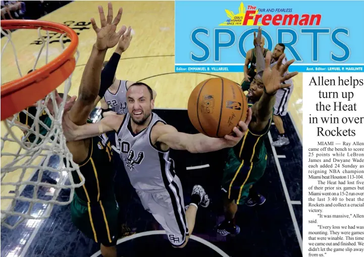  ??  ?? San Antonio Spurs' Manu Ginobili shoots around Utah Jazz's Derrick Favors during the first half of an NBA basketball game in San Antonio.