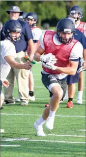  ??  ?? Conway Christian junior quarterbac­k Jacob Wood, left, hands the ball off to sophomore running back Wyatt Lawrence during a practice earlier this summer.