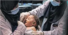  ?? | MAHMUD HAMS AFP ?? A NURSE holds 5-month-old Omar al-Hadidi at Al-Shifa Hospital.