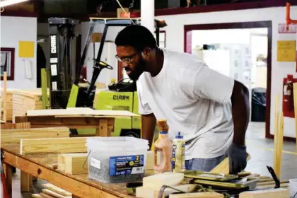  ??  ?? Demichael Potts, a client at Ability Works, builds wooden boxes and fulfills orders for their contracts with local businesses. (Photo by Emma Moffett-taylor, SDN)