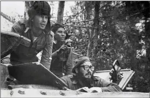  ?? (AP/CP, Granma, Raul Corrales, Files) ?? Cuban leader Fidel Castro (right) watches from a tank near Playa Giron, Cuba, during the Bay of Pigs invasion in this April 17, 1961, photo provided by Granma, the Cuban government newspaper. The part Arkansas Guardsmen played in training the invading Cuban exiles has slowly come to light over the years.