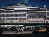  ?? (Bloomberg/Angel Garcia) ?? Tourists queue for onward travel at a cruise terminal in Barcelona,
Spain.