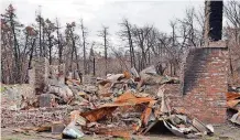  ??  ?? ABOVE: The home of Roy Dale and Ilajoy Covalt burned in the March 6 wildfires north of Woodward. BELOW: This equipment, owned by the Bentley family, was destroyed near Laverne in the March 6 wildfires.