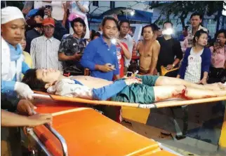  ?? NATIONAL POLICE ?? An injured victim is carried into an ambulance after a car accident that left three dead and six more seriously injured along Monivong Boulevard on Monday in Phnom Penh.