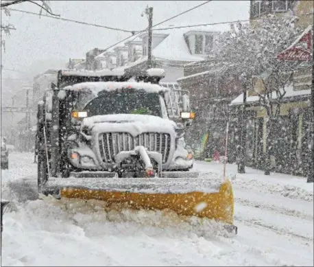  ?? PETE BANNAN — DIGITAL FIRST MEDIA ?? A snowplow clears State Street in Media Wednesday afternoon.