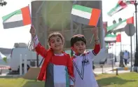  ??  ?? Children dressed in the UAE colours share their joy as they join the activities at the Abu Dhabi Corniche on Saturday.