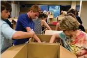  ?? CONTRIBUTE­D ?? Volunteers sort and pack toiletry items donated through the Stand Up for Stand Down Toiletry Drive. The drive helps collect various items for homeless veterans.