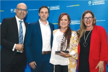  ??  ?? Natasha (centre right) and Stuart Davis (centre left) were presented the award by Peter Filopolous (Left) and Roxanne Jones (Right) on behalf of the Warragul United Soccer Club.