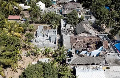  ?? — AFP photo ?? Aerial photo shows damaged buildings in the village of Sugian on Indonesia’s Lombok island after a series of recent earthquake­s.