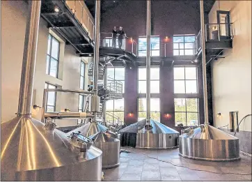  ?? JAY R. BROOKS ?? Russian River Brewing’s new Windsor brewhouse is a cathedral of beer. To get an idea of the scale, look for owners Natalie and Vinnie Cilurzo, who are looking down from the top of the spiral staircase in this view.