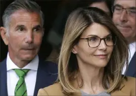  ?? Steven Senne/Associated Press ?? Actress Lori Loughlin and husband, clothing designer Mossimo Giannulli, left, depart federal court in Boston in April 2019 after facing charges in a nationwide college admissions bribery scandal.