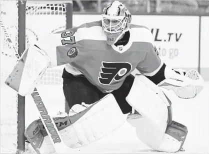  ?? TOM MIHALEK THE ASSOCIATED PRESS ?? Philadelph­ia Flyers goalie Brian Elliott in action. Officials hope to make goalies feel safe in chest protectors that are roughly an inch smaller and tighter to the body. Elliott complained of bruises early in the season.