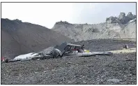  ?? AP ?? The photo provided by Police Graubuende­n shows the wreckage of the old-time propeller plane Ju 52 after it went down Saturday on the Piz Segnas mountain above the Swiss Alpine resort of Flims, striking the mountain’s western flank.