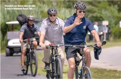  ?? AP ?? President Joe Biden rides his bike in July in Rehoboth Beach, Del.