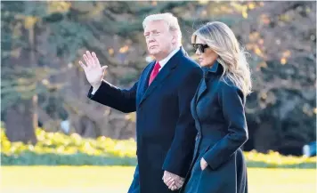  ?? EVAN VUCCI/AP ?? President Donald Trump and first lady Melania Trump walk to board Marine One on Wednesday at the White House. A massive coronaviru­s relief and government funding package is in danger after the president slammed it Tuesday night.