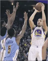  ?? BENMARGOT — THE ASSOCIATED PRESS, FILE ?? The Warriors’ Klay Thompson, right, shoots over the Nuggets’Will Barton (5) during the second half of their 2017game in Oakland.