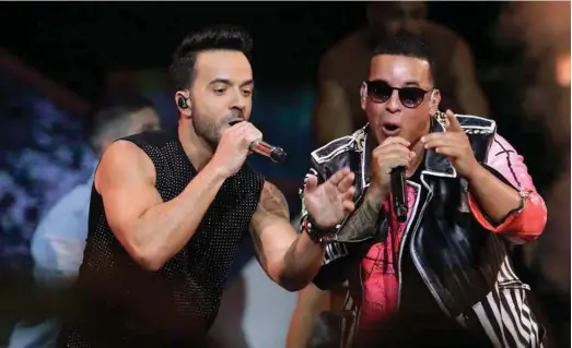  ??  ?? Clockwise from above; Luis Fonis, left, and Daddy Yankee perform Despacito at this year’s Billboard Latin Music Awards; Rihanna; Juan Saturria teaches reggaeton dance classes in Dubai; Shakira; Mohammed Assaf AP; Getty Images; Christophe­r Pike / The...