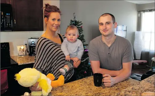  ?? Wil Andruschak/for the Calgary Herald ?? Ashley Irving and Mitch Vevang and their eight-month-old son, Olen, in their new home — a Walden Mix and Match duplex by Homes by Avi in Calgary.