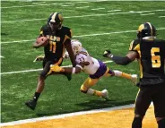  ?? (Pine Bluff Commercial/I.C. Murrell) ?? UAPB quarterbac­k Skyler Perry rushes for a touchdown early in the second quarter, breaking a tackle from Prairie View free safety Tariq Mulmore on Saturday at Simmons Bank Field.