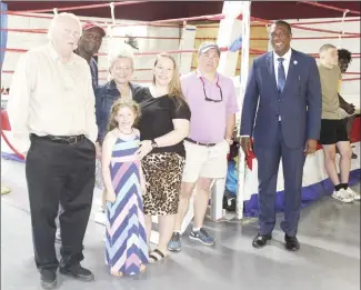  ?? Katie West • Times-Herald ?? Local leaders and supporters gathered for refresheme­nts and to tour the JB Fireballer’s new boxing center during a recent ribbon cutting. The new youth center is located on Lake Street. Above, from left, are: St. Francis County Judge Gary Hughes, Coach Jim Bailey, Kelly Lewis, Arya Andrews, Jamie Andrews, Forrest City Councilman Justin Reeves and Forrest City Mayor Cedric Williams.