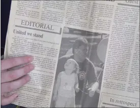  ?? BOB KEELER — MEDIANEWS GROUP ?? Morgan Reice holds a copy of a photo of her father and herself that ran in the Souderton Independen­t in September 2002.