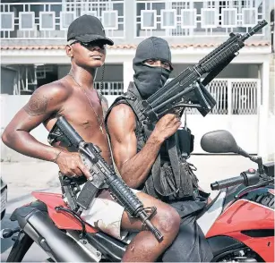  ?? SEBASTIANO TOMADA GETTY IMAGES FILE PHOTO ?? Members of the ADA gang in Villa Allianca, one of the non-pacified favelas of Rio de Janeiro. Killings reached a record 64,000 across Brazil in 2017 and the death toll remains high.