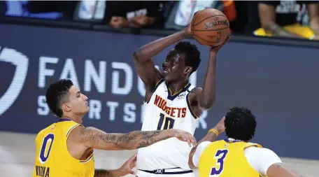  ?? Pool, Getty Images ?? Nuggets rookie Bol Bol (10) played the entire fourth quarters as head coach Michael Malone opted to stick with his reserves against the first-place Los Angeles Lakers.