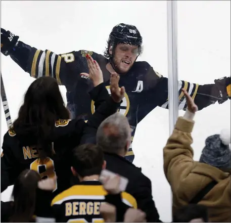  ?? MICHAEL DWYER — THE ASSOCIATED PRESS ?? Boston Bruins’ David Pastrnak celebrates after scoring against the New Jersey Devils for the second time in the second period of an NHL hockey game Saturday, Dec. 30, 2023, in Boston.