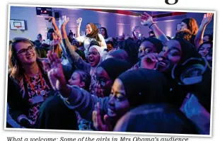  ??  ?? What a welcome: Some of the girls in Mrs Obama’s audience