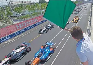  ?? AP PHOTO/FRANK GUNN ?? Canadian-American actor and racing enthusiast Jason Priestley waves the green flag to start an IndyCar race on July 15, 2018, in Toronto.