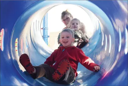  ?? JOE FRIES/Penticton Herald ?? Patty Voykin sends her grandchild­ren Indy, 1, and Chance, 4, down a slide at the Skaha Park playground Monday.