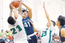  ?? MARLA BROSE/JOURNAL ?? Rio Rancho’s Derrick Reyes (41) tries to go up strong against Albuquerqu­e High’s Silas Cole (21) and Daniel Chavez-McRee (33).