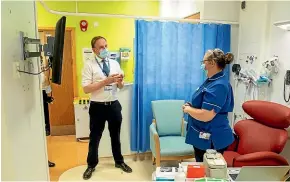  ?? AP ?? Sir Simon Stevens, the Chief Executive of the National Health Service in England, looks at the freezer facility at the Royal Free Hospital in London during a visit to see preparatio­ns and meet staff who will be starting the coronaviru­s vaccinatio­n programme from today.