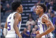  ?? HECTOR AMEZCUA/TRIBUNE NEWS SERVICE ?? The Sacramento Kings' De'Aaron Fox (5) shares a smile with teammate Buddy Hield (24) after Hield scored a 3point basket against the Washington Wizards on Oct. 26 in Sacramento.