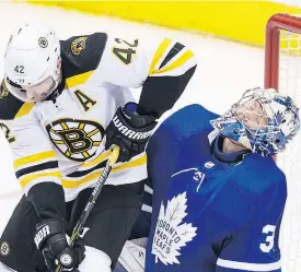  ??  ?? Maple Leaf goalie Frederik Andersen takes an elbow to the head from David Backes at the Air Canada Centre.