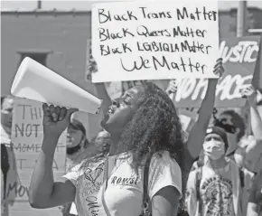  ?? ANGELA PETERSON / MILWAUKEE JOURNAL SENTINEL ?? Anna Sellers, also known as “Lady London,” lets her voice be heard when the more than 1,000 protesters stopped at First Street and National Avenue while participat­ing in the Pride march for Black Lives Matter that originated at Henry W. Maier Festival Park on Sunday.