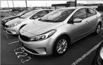  ?? ASSOCIATED PRESS ?? IN THIS TUESDAY June photograph, a used 2017 Kia Forte sits in a row of other used, late-model sedans at a dealership in Centennial, Colo. Prices of used small cars are on the rise after falling for the past five years.