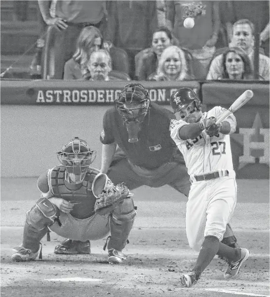  ?? Michael Ciaglo / Houston Chronicle ?? Astros second baseman Jose Altuve hits a double during a four-run second inning that chased Los Angeles starter Yu Darvish. The Astros went on to win 5-3.