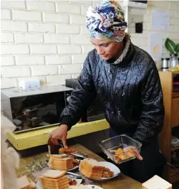  ??  ?? FRESH START: Chantel Sampson busies herself in the camp kitchen.